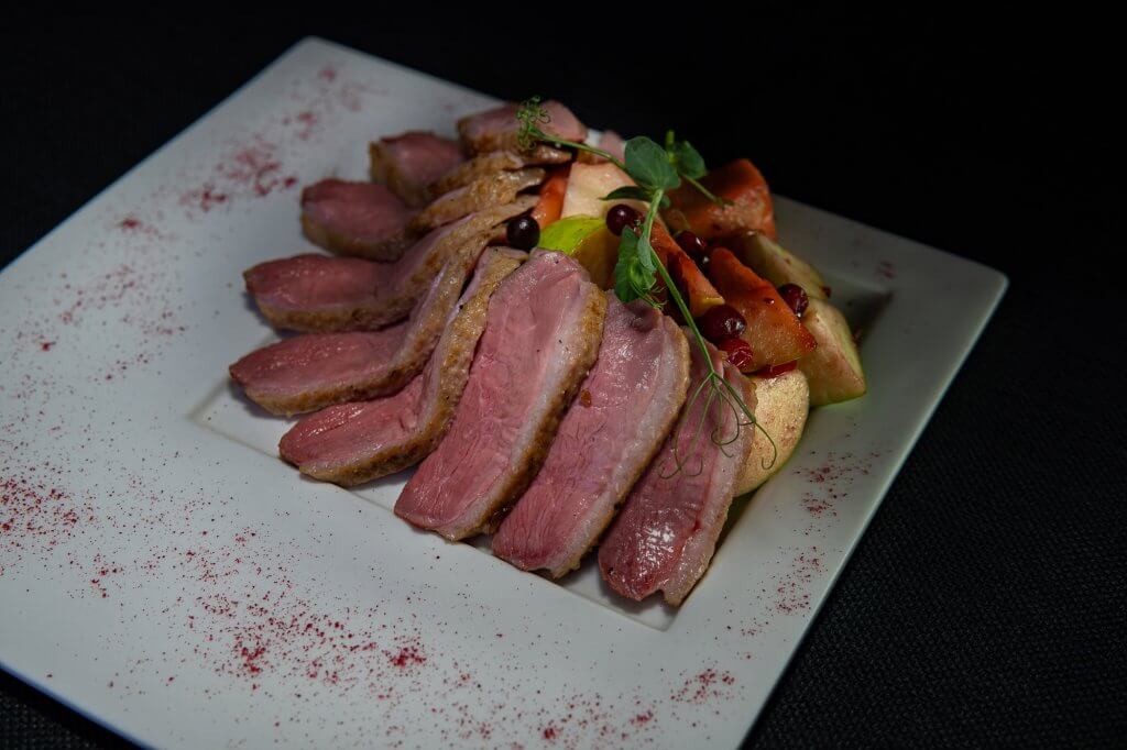 sliced duck breast with apples